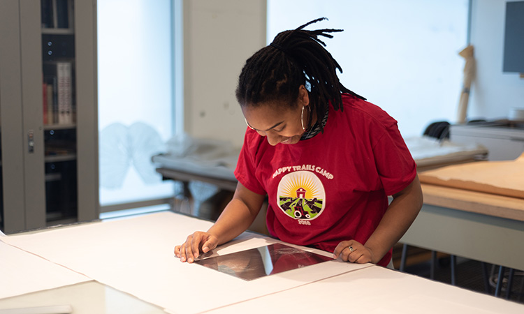 A student with a printing plate