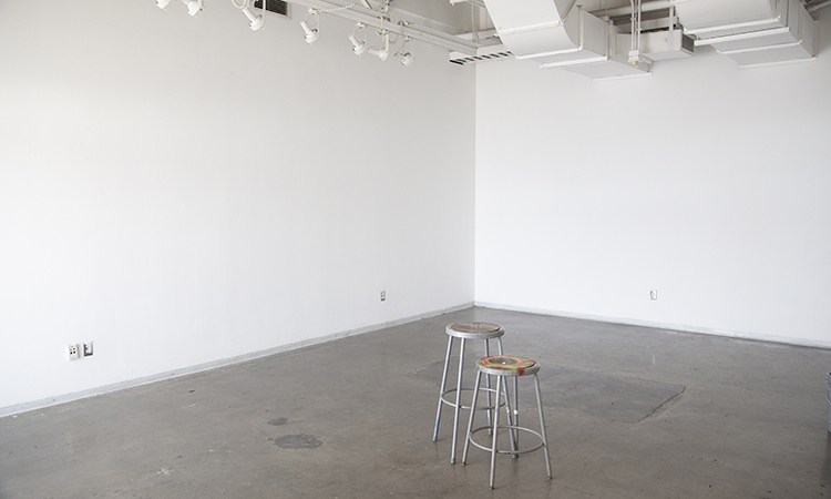 Stools in the center of an empty critique room