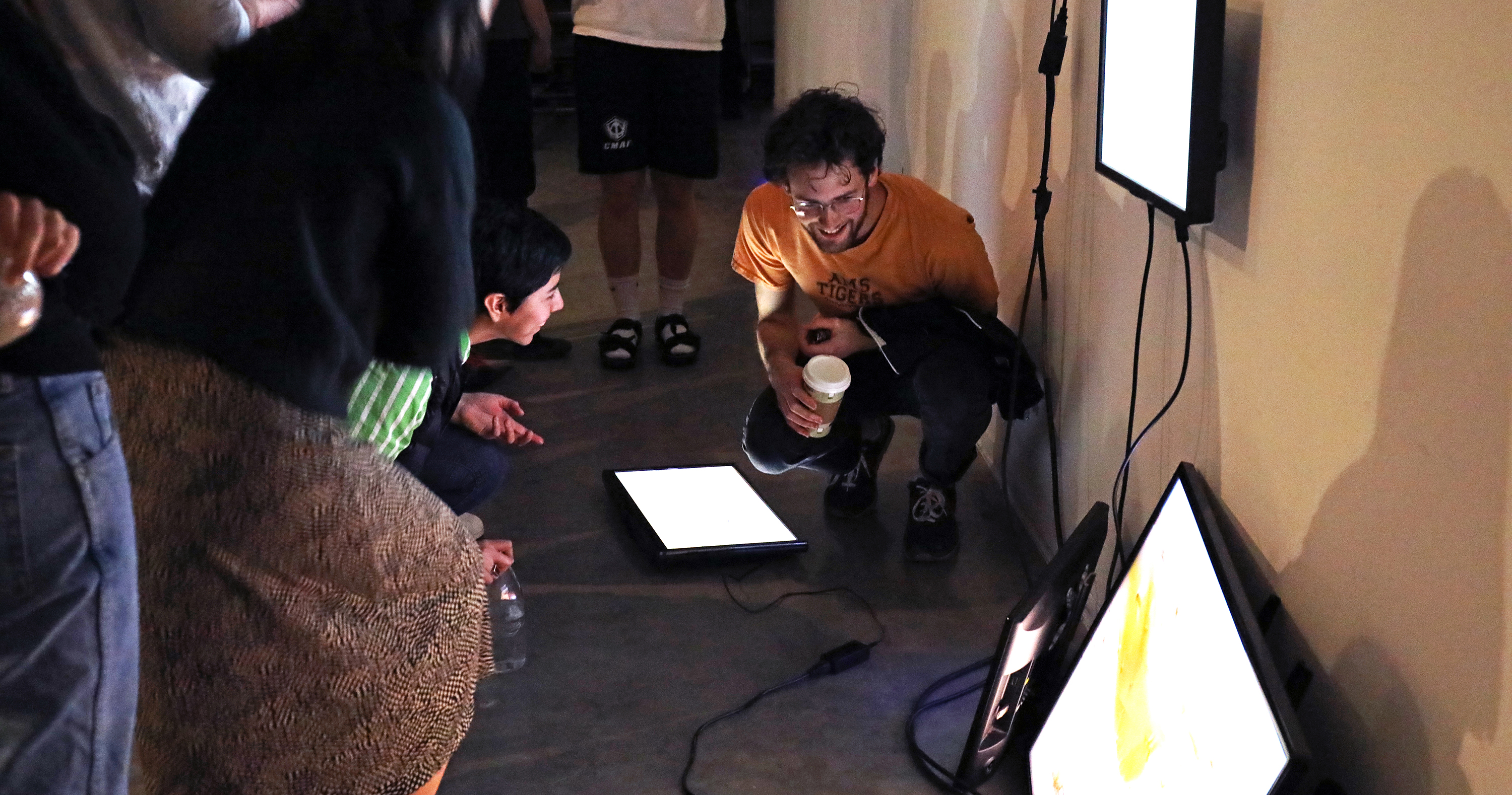 New Genres students viewing an installation of television monitors